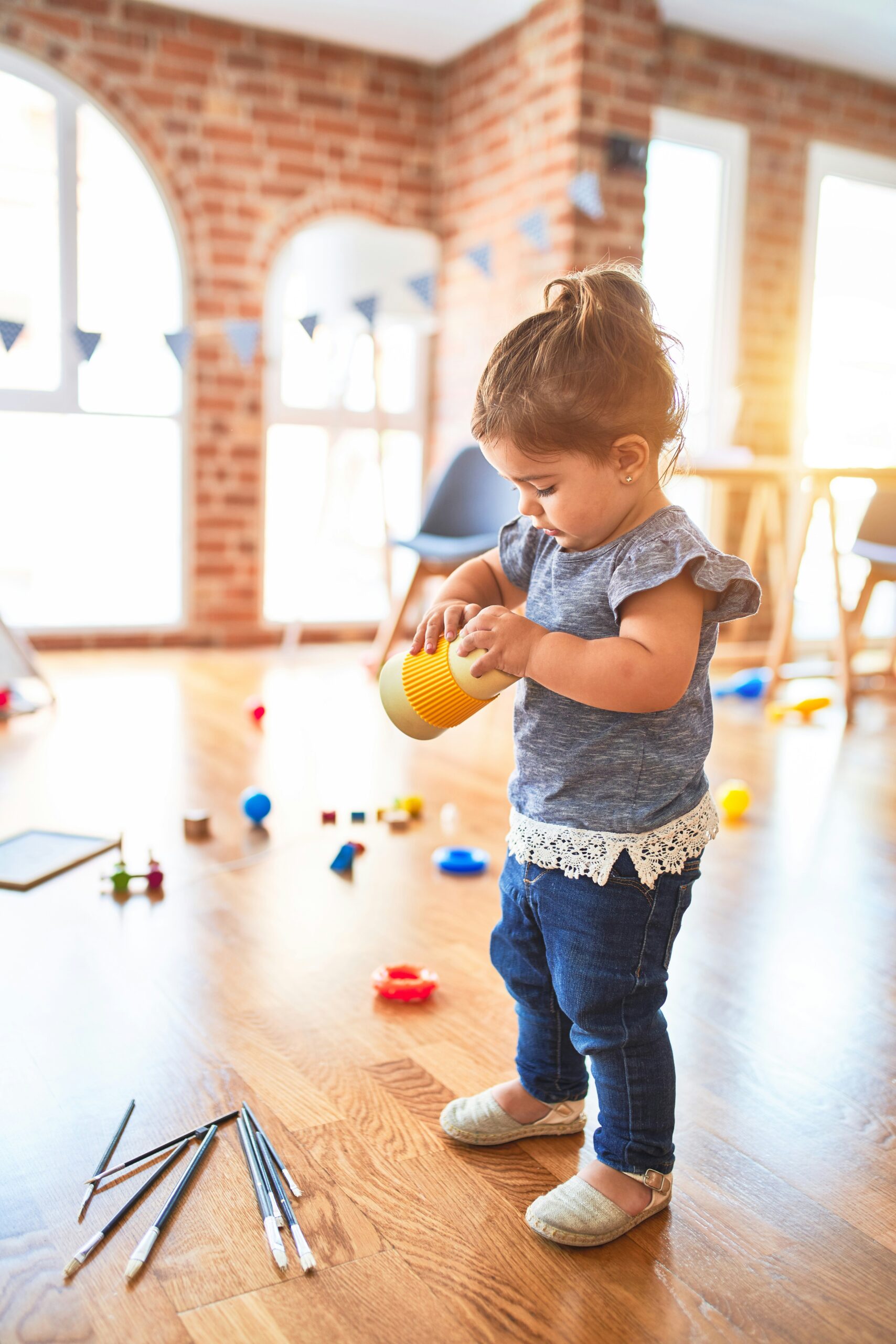 girl in blue denim dungaree pants holding blue and white polka dot handbag